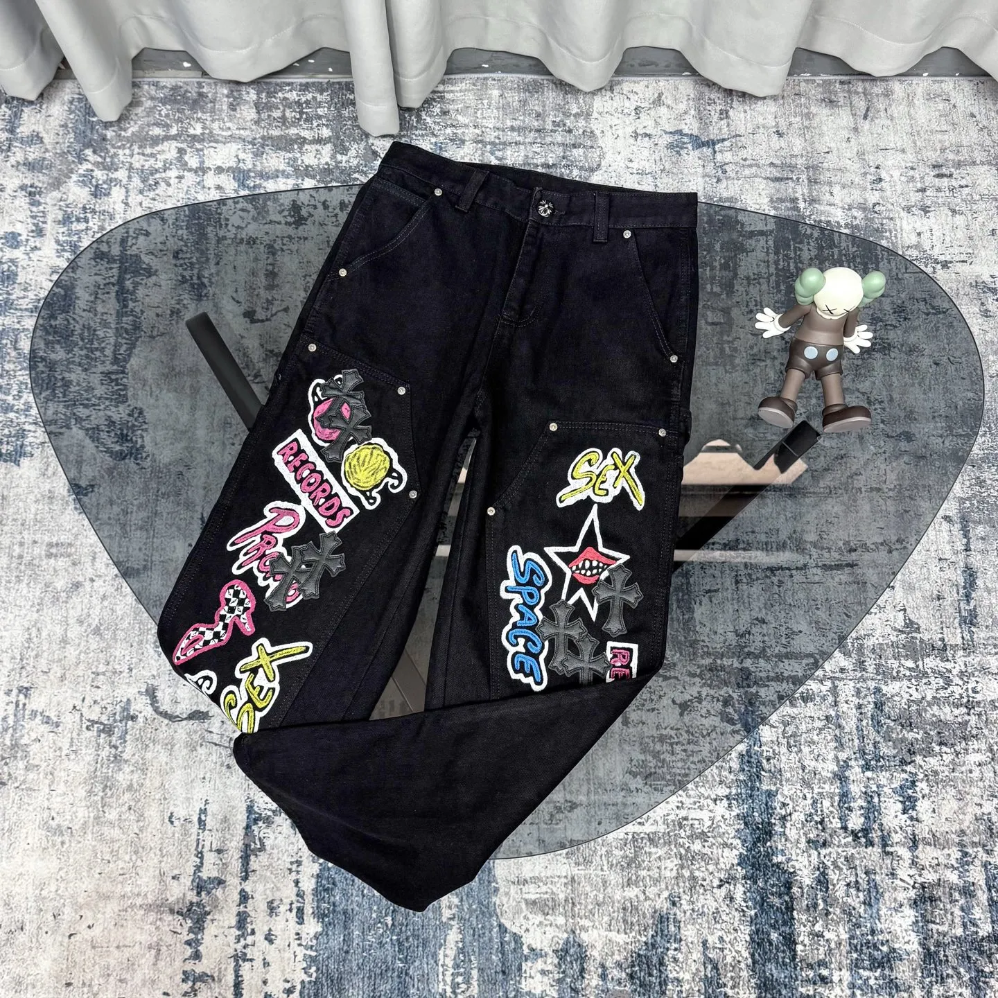 P260 Chrome Hearts Chrome Hearts black multi-element graffiti overalls Chrome Hearts clothing creative director Mattyboy Mattyboy, whose real name is Matt DiGiacomo, is a graffiti artist with a non-school background. He started to serve as the creative director of the Chrome Hearts clothing series in 2018. Since then, Chrome Hearts, which has been injected with young blood, has become popular again. Popular clothing and leather goods, especially the vintage trousers modified product line, must be pre-ordered in stores around the world. Especially patterns like Checker Ball, Checker Eyes and Smiling Lips. The fictional record company logo "SexRecords" often appears in his works, forming his unique style. "I hate humanity, but I love art. Before the end of my life, I just want to do my best to create." ----Matty Boy Mattyboy and vrigil Abloh are also very close. They are both ICONs who bring street culture into luxury accessories. Via.MattyBoy90 (IG) Size: 28/30/32/34/36 Waist: 69/74/79/84/89 Knee circumference: 50/51.5/53/54.5/56 Pants length: 102/104/106/108/110
